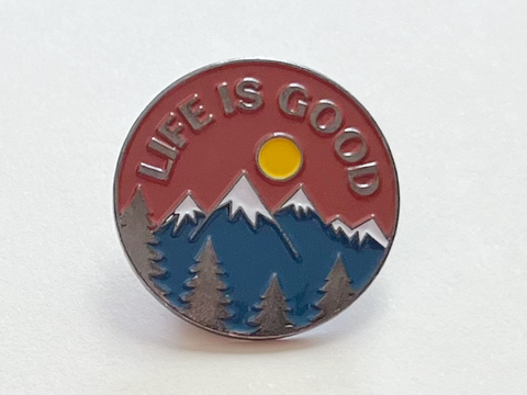 Camping Pin with Blue Mountains, Pine Trees, Sun, and Brown Sky Scene with Saying "Life is Good"