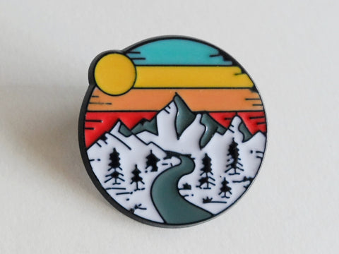 Camping Pin with Mountain, Trees, River & Orange Sunset Sky Scene