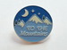 Camping Pin with Mountains, Pine Trees, Moon, and Blue Night Sky Scene with Saying "To The Mountains"
