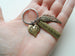 Bronze Twin Babies Memorial Keychain, Twins Feet Heart Charm & Wing Charm & Custom Engraved Tag by Jewelry Everyday
