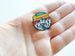 Camping Pin with Mountain, Trees, River & Orange Sunset Sky Scene