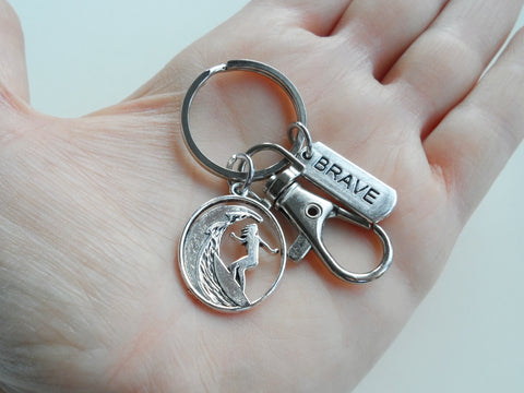 Surfing Keychain with a Girl Surfer Charm, Brave Charm, and Swivel Clasp