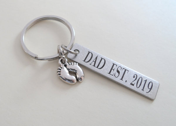 Dad Est. 2020 Engraved Rectangle Keychain with Baby Feet Charm; Father's Keychain